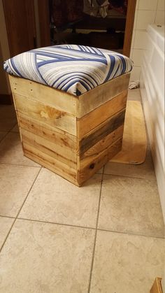 a wooden bench sitting on top of a tiled floor