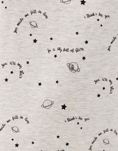 a white t - shirt with stars and planets on it