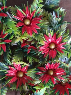 red and green poinsettis with gold balls on them