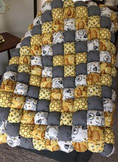 a quilt made to look like honeycombs and cats