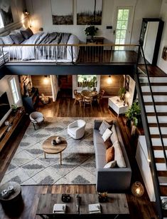 an aerial view of a living room and bedroom with stairs leading up to the second floor