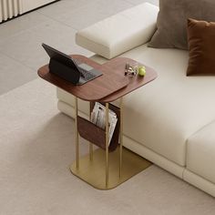 a table with a laptop on it next to a couch