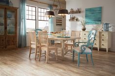 a dining room table and chairs in front of a window