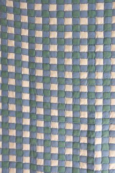 a blue and green checkered bedspread on a bed