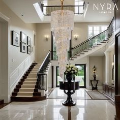 a large foyer with chandelier and stairs