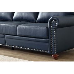 a blue leather couch with studded arms