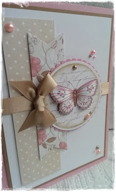 a close up of a greeting card with a butterfly on the front and a bow at the bottom