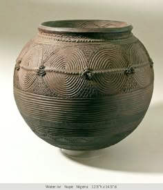 an old vase is sitting on a white surface with lines and circles drawn across it