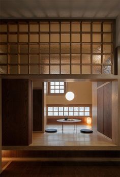 an empty room with wooden paneling and round table