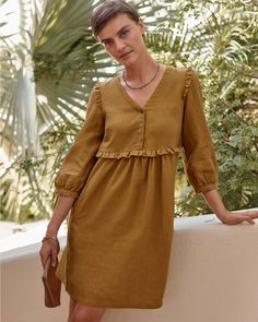 A summery statement of feminine style in soft linen, with well-placed ruffles at the shoulders and waist, flattering gathers, and blouson-style sleeves — plus pockets. Wear this pullover dress casual or dressy, for daytime or date night.  Exclusive. V-neckline with three-button placket. 3/4 sleeves with gathered, buttoned cuffs. Empire waist with gathers in front and back. Welt hand pockets. Well Dress Women, Botton Dresses, Empire Waist Dress Casual, Fashion Over Fifty, Garnet Hill, Empire Waist Dress, Knit Skirt, Linen Dresses, Dress Details