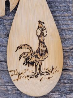 a wooden spoon with a drawing of a rooster on it