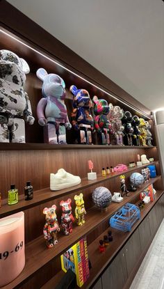 there are many stuffed animals on the shelves