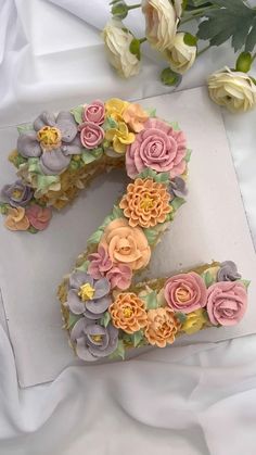 the number two cake is decorated with flowers