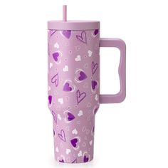 a purple cup with hearts on it and a straw sticking out of the cup's handle