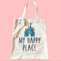 a tote bag that says, my happy place on it with a castle in the background