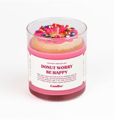 a candle that has sprinkles on it and is in a glass container