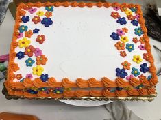 a decorated sheet cake sitting on top of a table