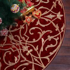 a red and gold christmas rug with ornaments on it