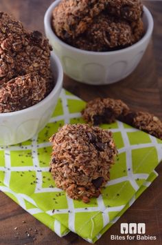 two bowls filled with granola cookies on top of a green napkin next to each other