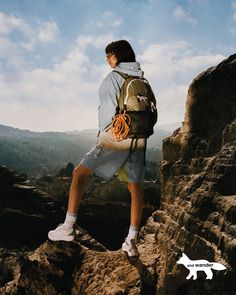 a man standing on top of a rocky cliff