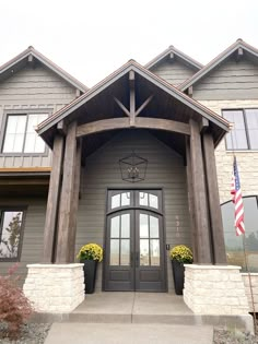 the front entrance to a large gray house