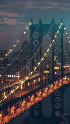 the lights on the bridge shine brightly at night