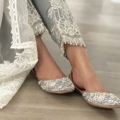 a close up of a person's feet wearing wedding shoes