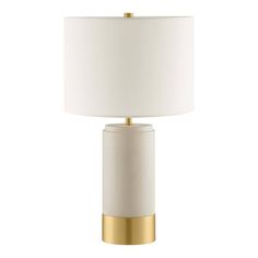 a white and gold table lamp with a white shade on the top, against a white background