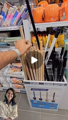 a person holding up an umbrella in front of a store display