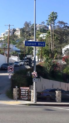 a street sign on the corner of sunset blvd