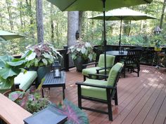 an outdoor deck with chairs, tables and umbrellas