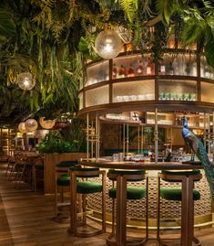 the inside of a restaurant with lots of green plants