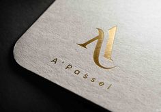 a close up of a logo on a white and gold business card that reads apossel