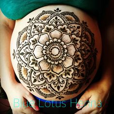 a pregnant woman's belly is decorated with hendix and flower designs on it