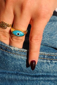 Give your digits the power to wave goodbye to negativity and beckon only admiring glances—light 'em up with this absolute classic in blue! Our fan favorite Evil Eye Ring is the good luck charm your wardrobe has been waiting, shining smartly with its invigorating sky blue evil eye lined in stately gold. Let your finger stacks start here and get ready to build a blinged-out dream that's totally, unmistakably you. Light Em Up, Tech Background, Wave Goodbye, Evil Eye Ring, Luck Charm, Blue Evil Eye, Eye Ring, Luck Charms, Gift Stickers