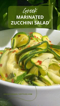 a white bowl filled with sliced zucchini salad