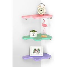 three shelves with two different colored shelves and a clock on the top one shelf has a pink flamingo