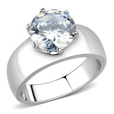 a white gold ring with a round cut diamond in the center, on a white background