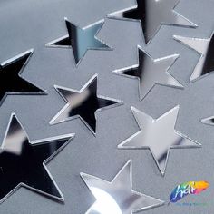 several shiny silver stars on a gray background