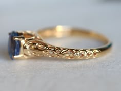 a gold ring with a blue stone in it