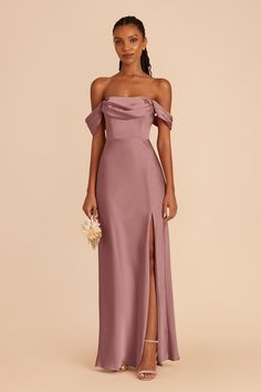 a woman in a purple dress with an off the shoulder slit