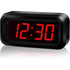 an alarm clock with red numbers on the display is shown in front of a white background