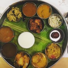 a large metal tray filled with different types of food