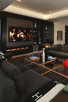 a living room filled with furniture and a flat screen tv mounted to the side of a wall