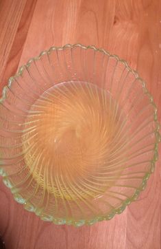 a glass bowl sitting on top of a wooden table