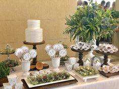 a table topped with lots of cake and flowers