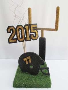 a football helmet on top of a fake grass field with the number 17 in front of it