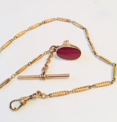 Victorian Watch Chain Goldfilled w 9K Gold Carnelian Seal Fob, TBar, Swivel, Hallmarks 375 Gold Fill Watch Chain with a 9 K Gold Seal Fob, unmarked. 2 Hallmarks on the seal Fob, including 375 and an anchor. Another hallmark on the ring near the swivel. In very good antique condition. A particularly lovely seal.  14 1/2 inches long. Fob Chain Necklace, Antique Jewelry With Polished Oval Link Finish, Antique Oval Link Jewelry With Polished Finish, Antique Formal Jewelry With Gold Clasp, Heirloom Link Jewelry For Formal Occasions, Victorian Watch, Vintage Repurposed, Charm Chain, Watch Chain