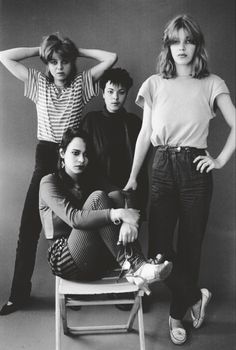 the runaways posing for a photo in front of a gray background with their hands on their head