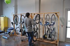 a person working on some bikes in a room